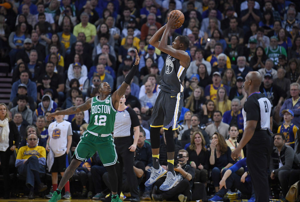 Kevin Durant #35 of the Golden State Warriors shoots over Terry Rozier #12 of the Boston Celtics during their NBA basketball game at ORACLE Arena on January 27, 2018 in Oakland, California.  (Photo by Thearon W. Henderson/Getty Images)