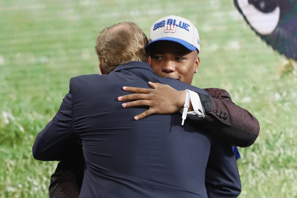 Saquon Barkley of Penn State hugs NFL Commissioner Roger Goodell after being picked #2 overall by the New York Giants during the first round of the 2018 NFL Draft at AT&T Stadium on April 26, 2018 in Arlington, Texas.  (Ronald Martinez/Getty Images)