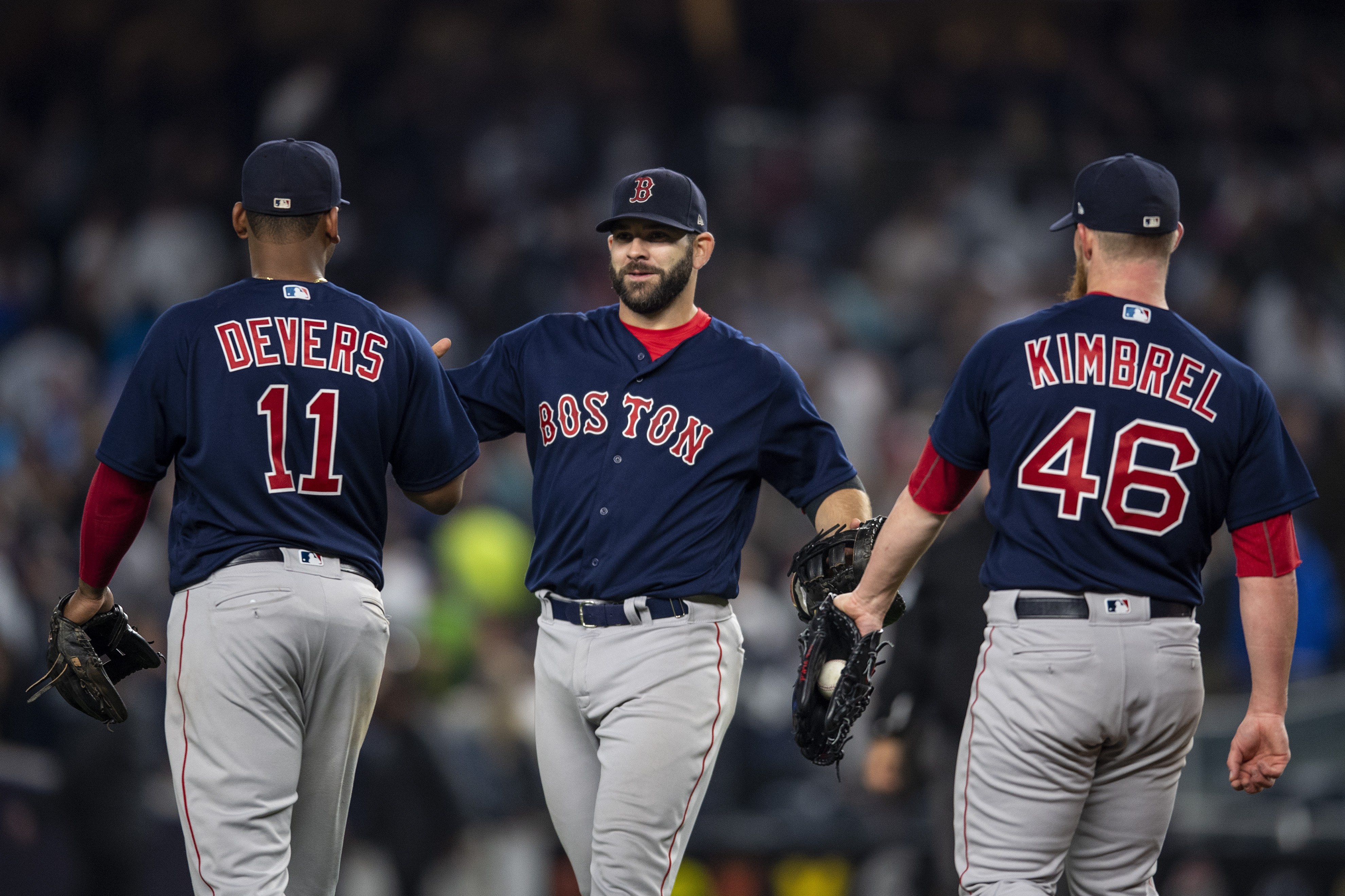 Mitch Moreland #18, Rafael Devers #11 and Craig Kimbrel #46 of the Boston Red Sox celebrate a victory  against the New York Yankees on May 10, 2018 at Yankee Stadium in the Bronx borough of New York City. (Photo by Billie Weiss/Boston Red Sox/Getty Images)
