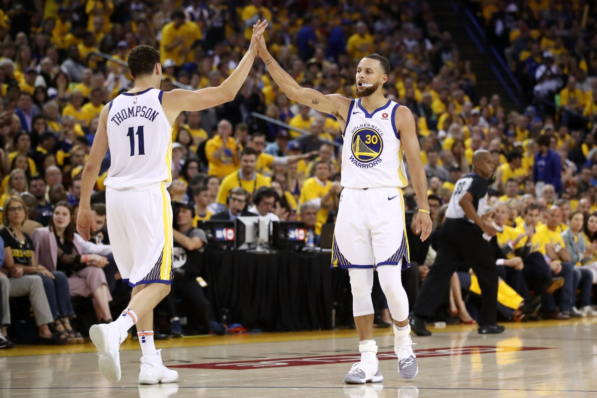 Stephen Curry #30 and Klay Thompson #11 of the Golden State Warriors react after a plat against the Houston Rockets during Game Three of the Western Conference Finals of the 2018 NBA Playoffs at ORACLE Arena on May 20, 2018 in Oakland, California. (Photo by Ezra Shaw/Getty Images)
