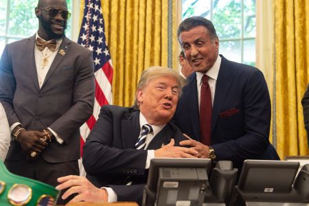President Donald Trump jokes with actor Sylvester Stallone(R) before signing a posthumous pardon for former world champion boxer Jack Johnson in the Oval Office at the White House in Washington, DC, on May 24, 2018, as boxer Lennox Lewis looks on. (NICHOLAS KAMM / AFP/Getty)  