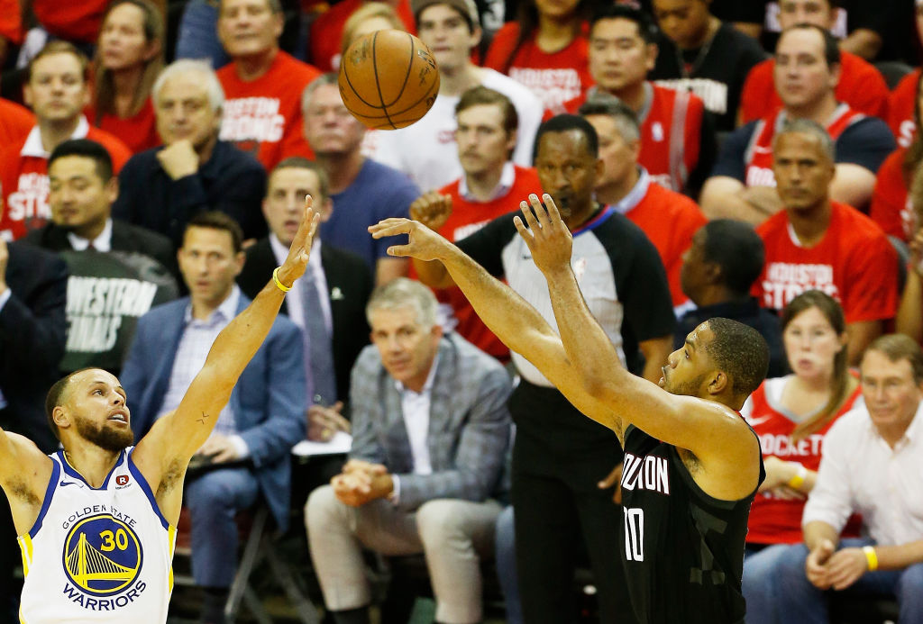 Eric Gordon #10 of the Houston Rockets shoots against Stephen Curry #30 of the Golden State Warriors in the first half of Game Five of the Western Conference Finals of the 2018 NBA Playoffs at Toyota Center on May 24, 2018 in Houston, Texas.  (Photo by Bob Levey/Getty Images)