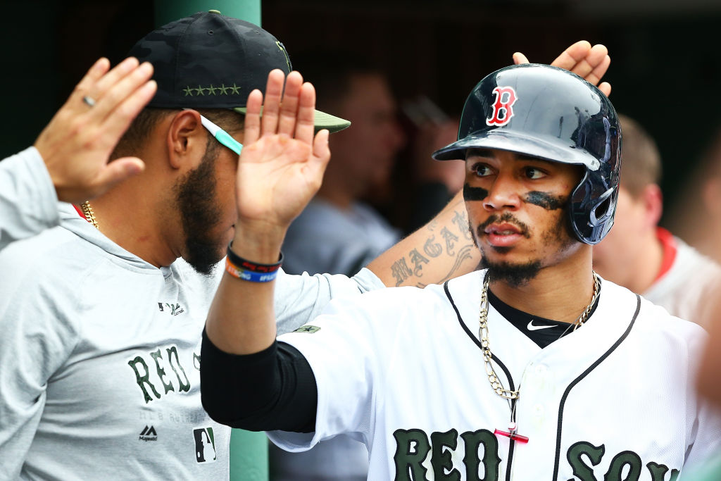 Mookie Betts #50 of the Boston Red Sox returns to the dugout after scoring in the sixth inning of a game against the Atlanta Braves at Fenway Park on May 26, 2018 in Boston, Massachusetts.  (Photo by Adam Glanzman/Getty Images)