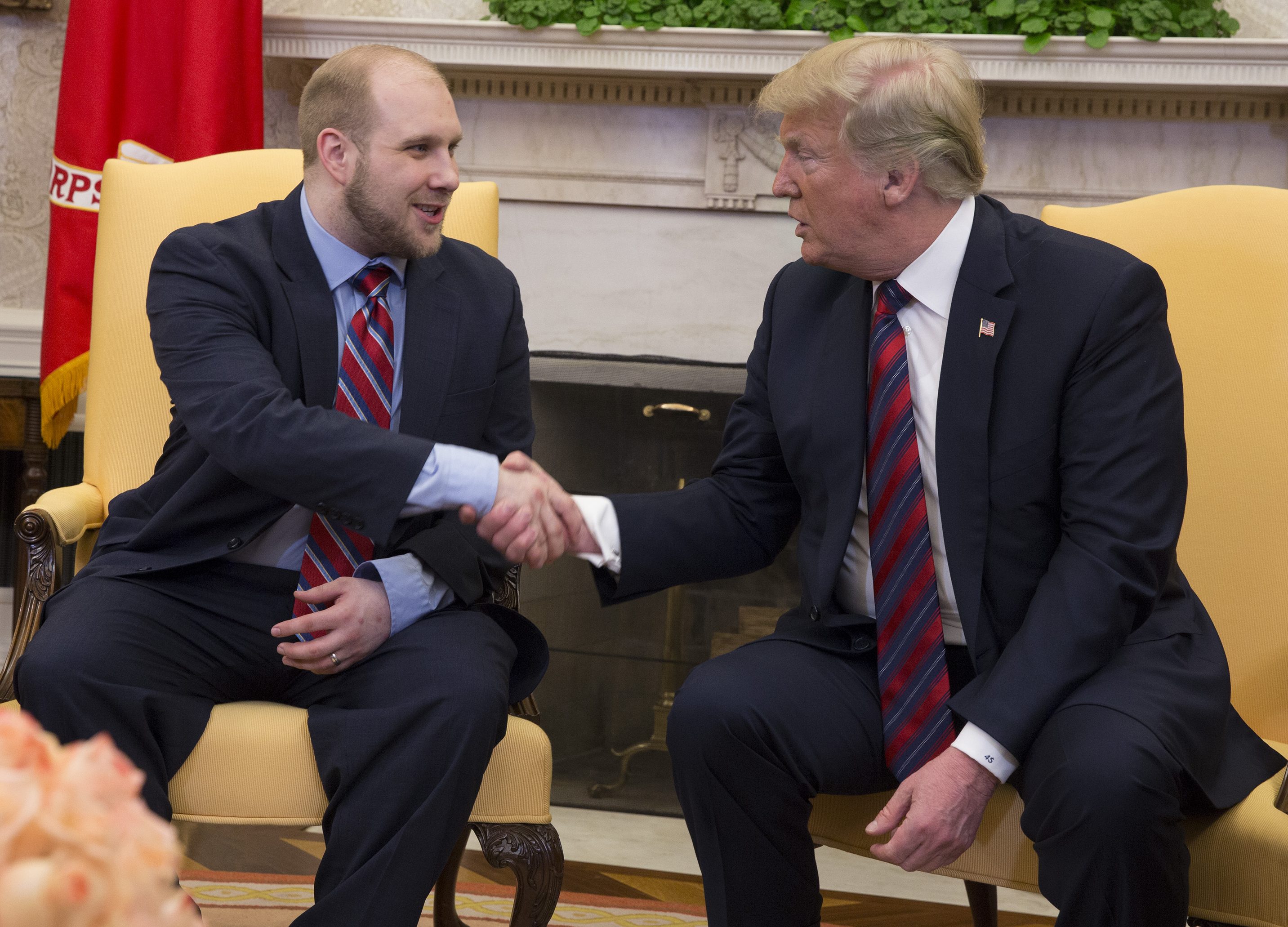 U.S. President Donald Trump shake hands during a meeting with Joshua Holt after his return to the U.S. at the White House on May 26, 2018 in Washington, DC. Holt, who had been imprisoned in Venezuela for two years, was released following diplomat efforts by the Trump and Obama administrations. (Photo by Chris Kleponis - Pool/Getty Images)