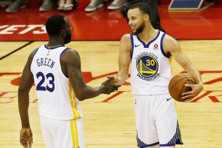 Stephen Curry #30 and Draymond Green #23 of the Golden State Warriors celebrate after they defeated the Houston Rockets 101 to 92 in Game Seven of the Western Conference Finals of the 2018 NBA Playoffs at Toyota Center on May 28, 2018 in Houston, Texas.(Photo by Bob Levey/Getty Images)