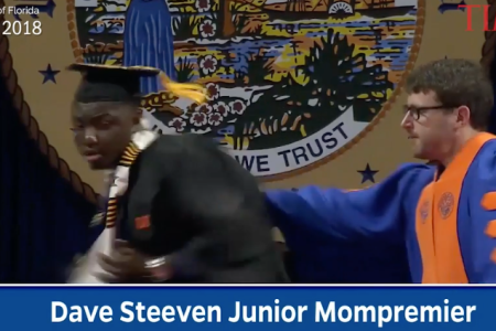 A screengrab from the commencement ceremony, in which a white faculty member rushed celebrating black students off the stage (Time)