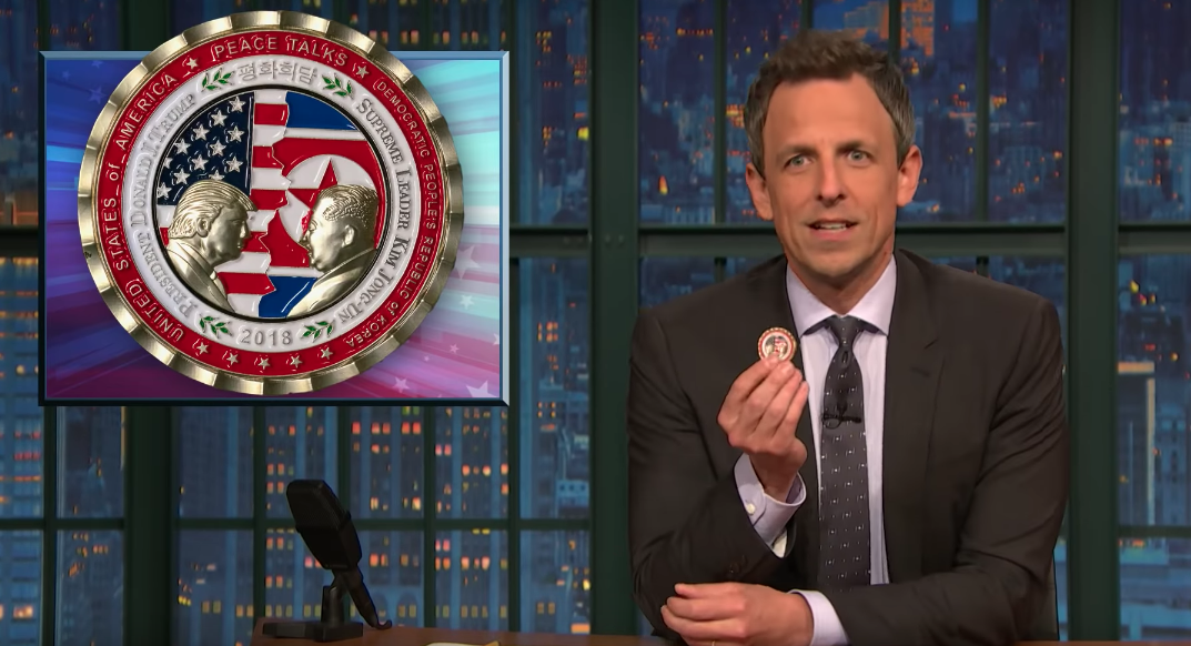 Seth Meyers holds up the now-defunct peace talks coin President Trump commissioned to be made for the North Korea talks (YouTube)