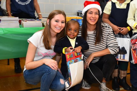 (L to R) The Fashion Foundation founder Amanda Munz, a student  at a Brooklyn elementary school who received donated supplies and designer Rebecca Minkoff on December, 2016. (Courtesy of Amanda Munz)