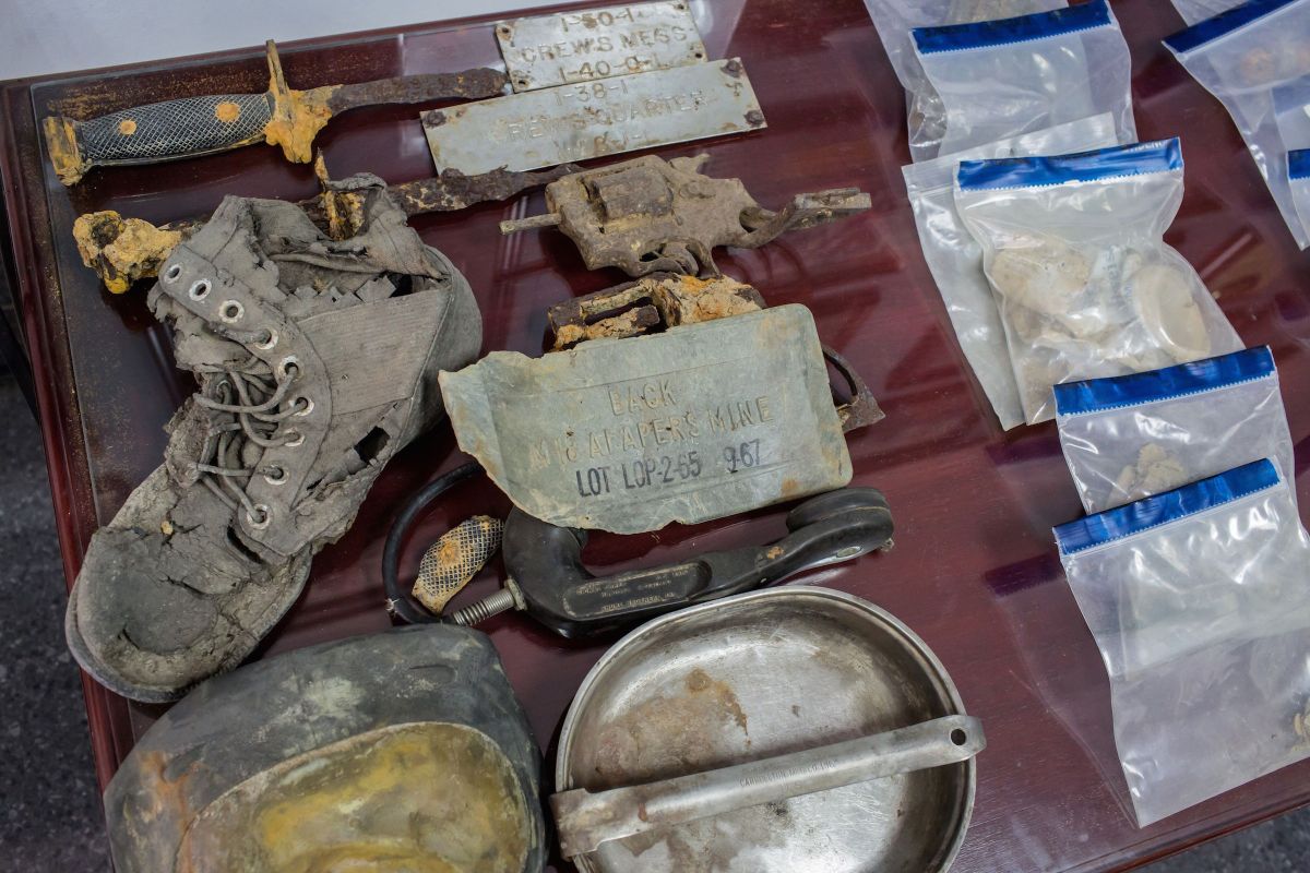 This picture taken on April 8, 2018 shows recovered weapons and personal belongings to missing US soldiers in Vietnam displayed at the Defense POW/MIA Accounting Agency in Hanoi. - The Defense POW/MIA Accounting Agency (DPAA) has been working in Vietnam for more than 30 years, before the former war foes established diplomatic ties in 1995. The agency was born out of a war-era effort by the wives of US POWs in Vietnam who demanded US leaders do more to get their imprisoned husbands home. (Photo by Thanh NGUYEN / AFP) / TO GO WITH Vietnam-war-history-remains,FEATURE by Jenny Vaughan and Quy Le Bui        (Photo credit should read THANH NGUYEN/AFP/Getty Images)