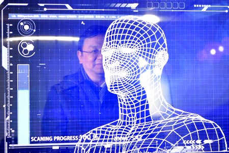 A manager of China's leading new energy vehicle maker BYD tries the facial recognition for starting a "Yungui" train during the launching of the "Yungui" system, a driverless monorail transit system, in Yinchuan, capital of northwest China's Ningxia Hui Autonomous Region, Jan. 10, 2018.
(Xinhua/Wang Peng via Getty Images)