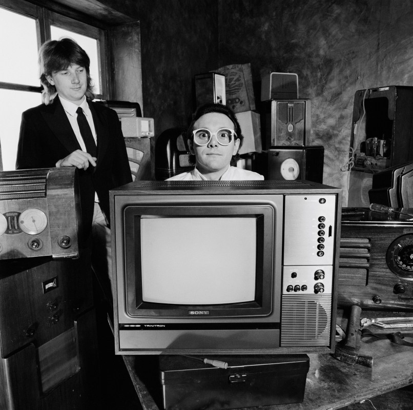Geoff Downes (left) and Trevor Horn (right) from the group Buggles pose together with various radios and a television in London in June 1979. (Fin Costello/Redferns)