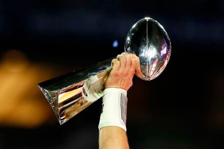 Tom Brady #12 of the New England Patriots celebrates holding the Vince Lombardi Trophy after defeating the Seattle Seahawks during Super Bowl XLIX at University of Phoenix Stadium on February 1, 2015 in Glendale, Arizona. The Patriots defeated the Seahawks 28-24.  (Photo by Kevin C. Cox/Getty Images)