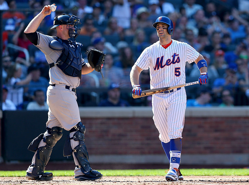 David Wright #5 of the New York Mets walks back to the dugout past Brian McCann #34 of the New York Yankees after Wright struck out with bases loaded in the seventh inning during interleague play on September 19, 2015 at Citi Field in the Flushing neighborhood of the Queens borough of New York City. (Photo by Elsa/Getty Images)