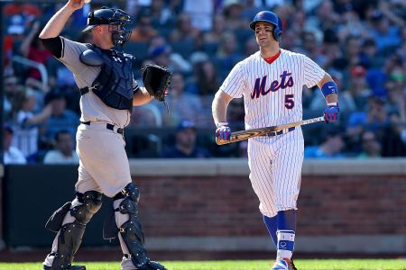 David Wright #5 of the New York Mets walks back to the dugout past Brian McCann #34 of the New York Yankees after Wright struck out with bases loaded in the seventh inning during interleague play on September 19, 2015 at Citi Field in the Flushing neighborhood of the Queens borough of New York City. (Photo by Elsa/Getty Images)