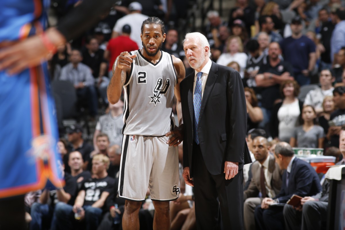 Kawhi Leonard #2 speaks with head coach, Gregg Popovich of the San Antonio Spurs during the game against the Oklahoma City Thunder on March 12, 2016 at AT&T in San Antonio, Texas. (Photo by Chris Covatta/NBAE via Getty Images)