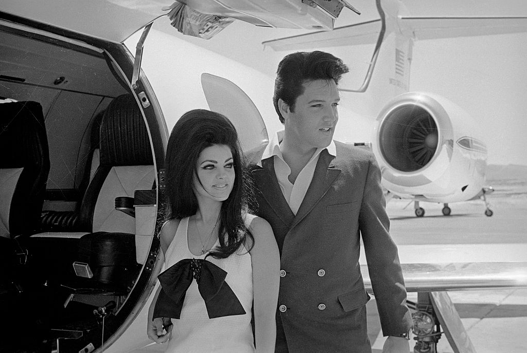 Newlyweds Elvis and Priscilla Presley, who met while Elvis was in the Army, prepare to board their private jet following their wedding at the Aladdin Resort and Casino in Las Vegas. (Getty Archives)