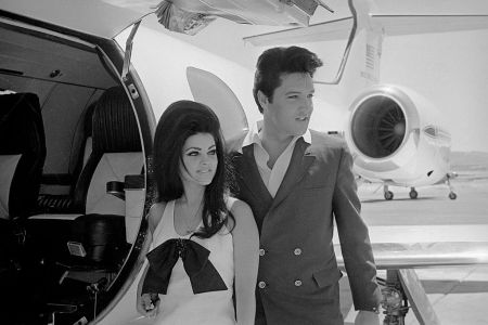 Newlyweds Elvis and Priscilla Presley, who met while Elvis was in the Army, prepare to board their private jet following their wedding at the Aladdin Resort and Casino in Las Vegas. (Getty Archives)