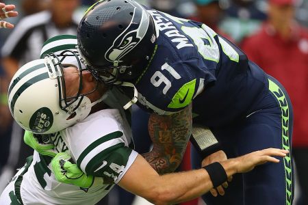 Cassius Marsh #91 of the Seattle Seahawks hits his helmet against quarterback Ryan Fitzpatrick #14 of the New York Jets for a penalty 'Roughing the Passer' in the second quarter at MetLife Stadium on October 2, 2016 in East Rutherford, New Jersey.  (Photo by Al Bello/Getty Images)