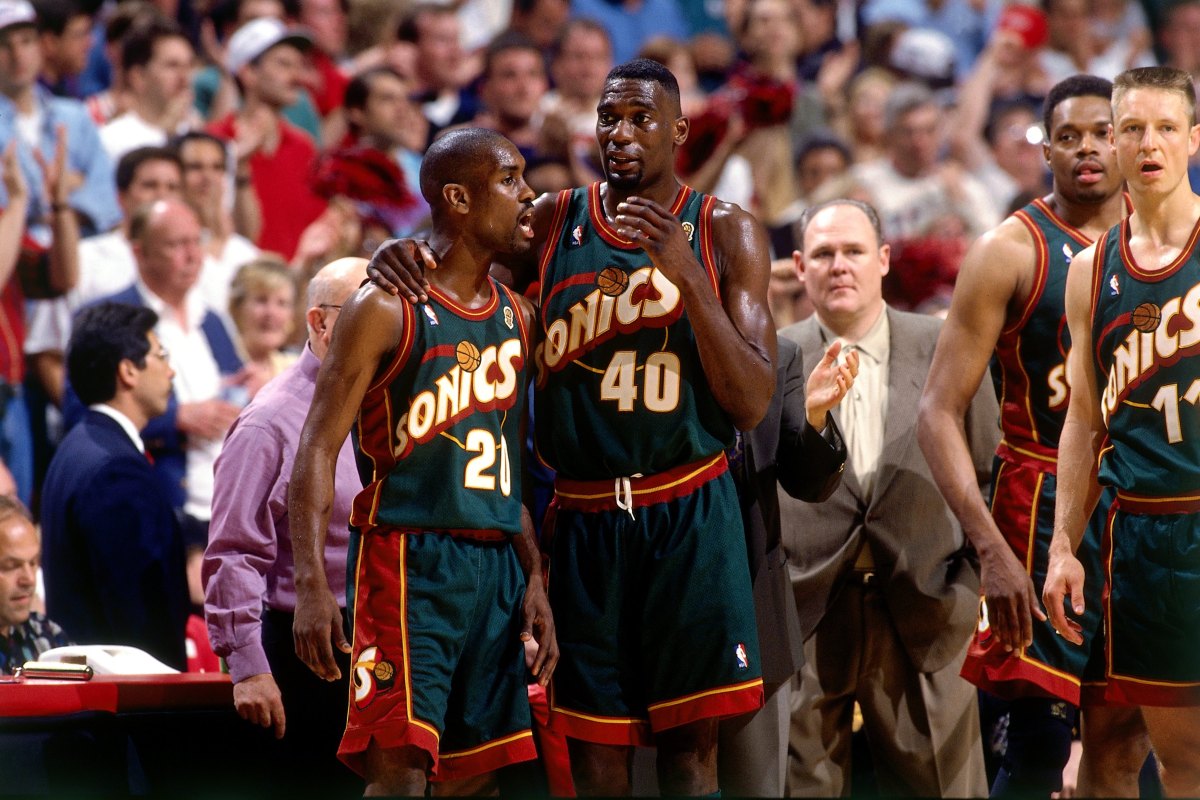 Shawn Kemp #40 and Gary Payton #20 of the Seattle SuperSonics discuss strategy during Game Six of the 1996 NBA Finals against the Chicago Bulls at the United Center on June 16, 1996 in Chicago Iillinois.  The Bulls won 87-75.  (Andrew D. Bernstein/NBAE via Getty Images)