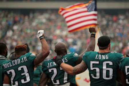 PHILADELPHIA, PA - OCTOBER 08: Rodney McLeod #23, Malcolm Jenkins #27 of the Philadelphia Eagles raise their fists in protest during the playing of the National Anthem as teammate Chris Long #56 shows support before a game against the Arizona Cardinals at Lincoln Financial Field on October 8, 2017 in Philadelphia, Pennsylvania. (Photo by Rich Schultz/Getty Images)