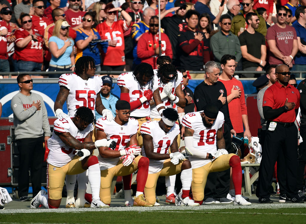 Several members of the San Francisco 49ers kneel during the anthem prior to the football game against Los Angeles Rams at Los Angeles Memorial Coliseum on December 31, 2017 in Los Angeles, California. (Photo by Kevork Djansezian/Getty Images)