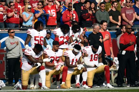 Several members of the San Francisco 49ers kneel during the anthem prior to the football game against Los Angeles Rams at Los Angeles Memorial Coliseum on December 31, 2017 in Los Angeles, California. (Photo by Kevork Djansezian/Getty Images)