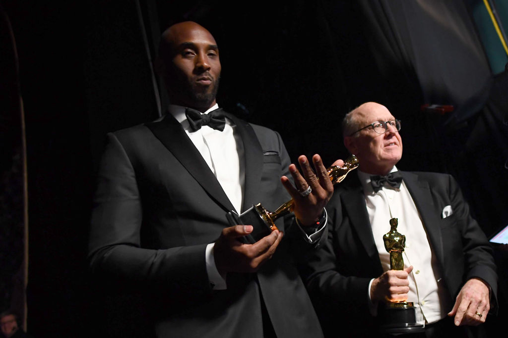 In this handout provided by A.M.P.A.S., filmmakers Kobe Bryant (L) and Glen Keane, winners of the Best Animated Short Film award for 'Dear Basketball,' attend the 90th Annual Academy Awards at the Dolby Theatre on March 4, 2018 in Hollywood, California.  (Photo by Matt Petit/A.M.P.A.S via Getty Images)