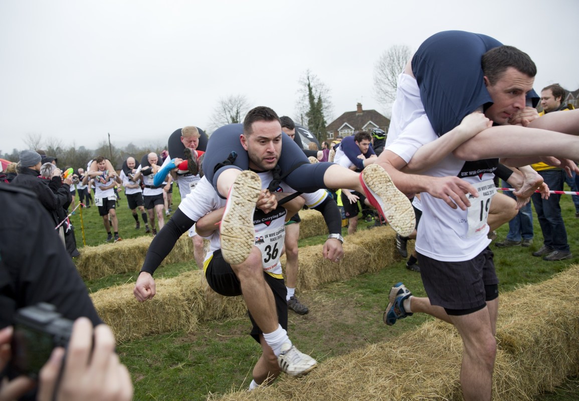 Competitors take part in the 2018 Wife Carrying Race in Dorking, Surrey, England on April 8, 2018." (Isabel Infantes/Anadolu Agency/Getty Images)