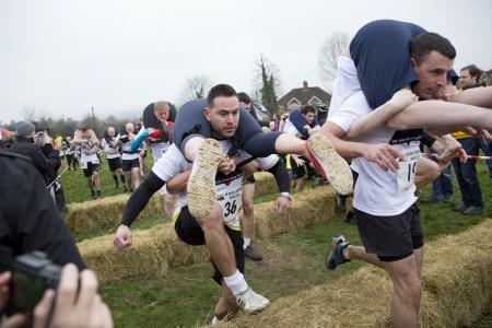 Competitors take part in the 2018 Wife Carrying Race in Dorking, Surrey, England on April 8, 2018." (Isabel Infantes/Anadolu Agency/Getty Images)