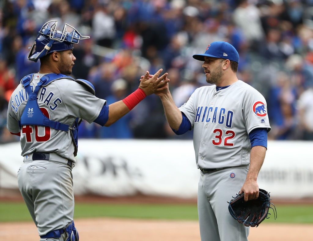 Willson Contreras #40 and Brian Duensing #32 of the Chicago Cubs celebrate a 2-0 win against the New York Mets during their game at Citi Field on June 3, 2018 in New York City. (Photo by Al Bello/Getty Images)