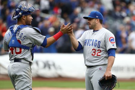 Willson Contreras #40 and Brian Duensing #32 of the Chicago Cubs celebrate a 2-0 win against the New York Mets during their game at Citi Field on June 3, 2018 in New York City.  (Photo by Al Bello/Getty Images)
