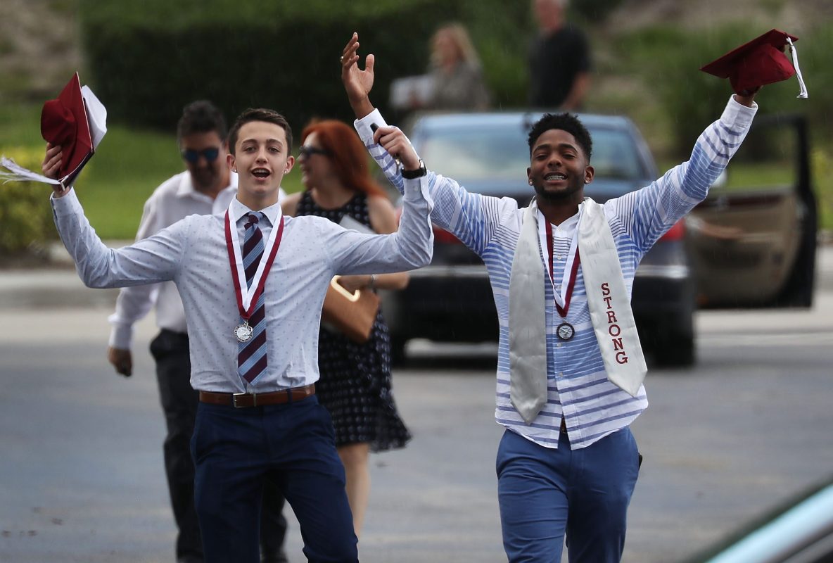 Graduates of  Marjory Stoneman Douglas High School are seen as they head to their cars after attending their graduation ceremony at the BB&T Center on June 3, 2018 in Sunrise, Florida. Fourteen students and three staff members died in the Feb. 14th attack by Nikolas Cruz. (Photo by Joe Raedle/Getty Images)
