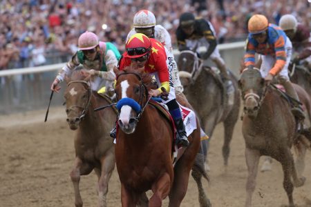 Justify with Mike Smith up wins the Belmont Stakes and Triple Crown for trainer Bob Baffert at Belmont Park Racetrack on June 09, 2018 in Elmont, New York (Photo by Horsephotos/Getty Images)