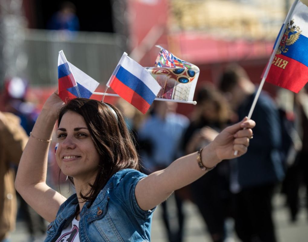 A woman wears Russian flags on her head during the opening ceremony of the FIFA Fan Fest in Nizhny Novgorod on June 14, 2018, ahead of the Russia 2018 World Cup. (Photo by MARTIN BERNETTI/AFP/Getty Images)