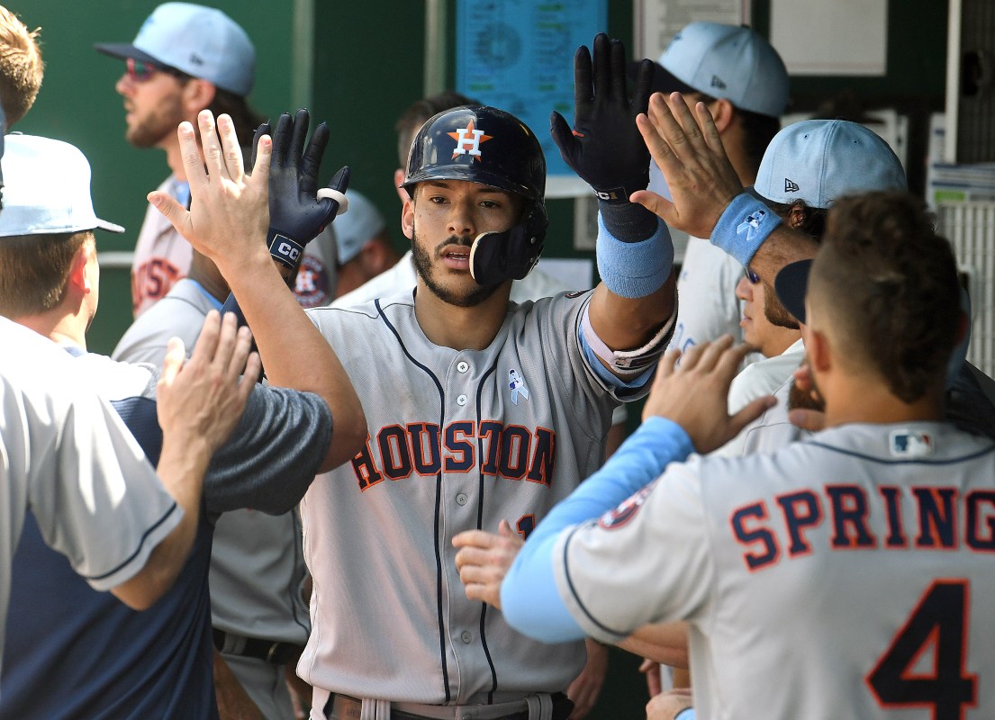 Houston Astros shortstop Carlos Correa (1) is congratulated in the dugout after tying the game in the eighth inning with a solo home run during a Major League Baseball game between the Houston Astros and the Kansas City Royals on June 17, 2018, at Kauffman Stadium, Kansas City, MO.  Houston won, 7-4. (Photo by Keith Gillett/Icon Sportswire via Getty Images)