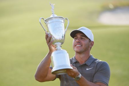 Brooks Koepka of the United States celebrates with the U.S. Open Championship trophy after winning the 2018 U.S. Open at Shinnecock Hills Golf Club on June 17, 2018 in Southampton, New York.  (Photo by Ross Kinnaird/Getty Images)