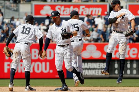 Didi Gregorius #18, Giancarlo Stanton #27, Gleyber Torres #25 and Aaron Judge #99 of the New York Yankees celebrate after defeating the Seattle Mariners at Yankee Stadium on June 21, 2018 in the Bronx borough of New York City. The Yankees defeated the Mariners 4-3.  (Photo by Jim McIsaac/Getty Images)