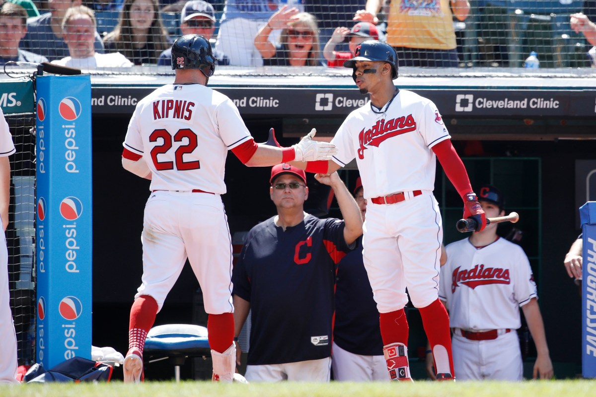 Jason Kipnis #22 of the Cleveland Indians is congratulated by Francisco Lindor #12 after hitting a solo home run in the eighth inning against the Detroit Tigers at Progressive Field on June 24, 2018 in Cleveland, Ohio. The Indians won 12-2. (Photo by Joe Robbins/Getty Images)