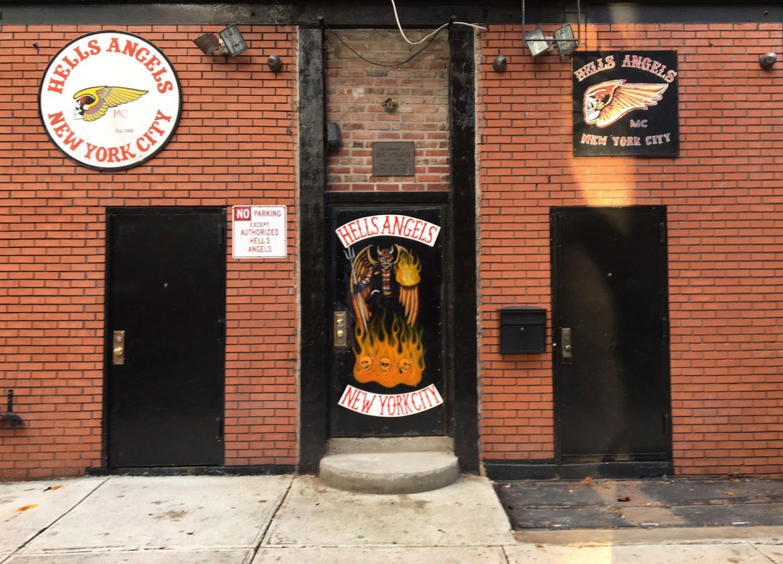 A sign near the front door of the Hells Angels motorcycle club headquarters in New York reads "No Parking Except Authorized Hells Angels," Friday, Dec. 16, 2016. Earlier in the week an out-of-town man was shot after moving an orange cone meant to save a parking space for club members. The secretive group has frustrated police by refusing to help identify the shooter. (AP Photo/Tom Hays)