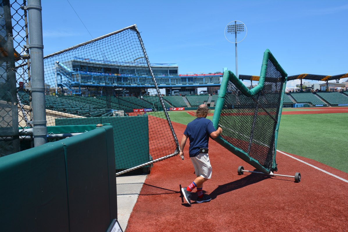 Max Colten wheels out more screens for batting practice at Municipal Credit Union Park in Coney Island. (Robert Marston)