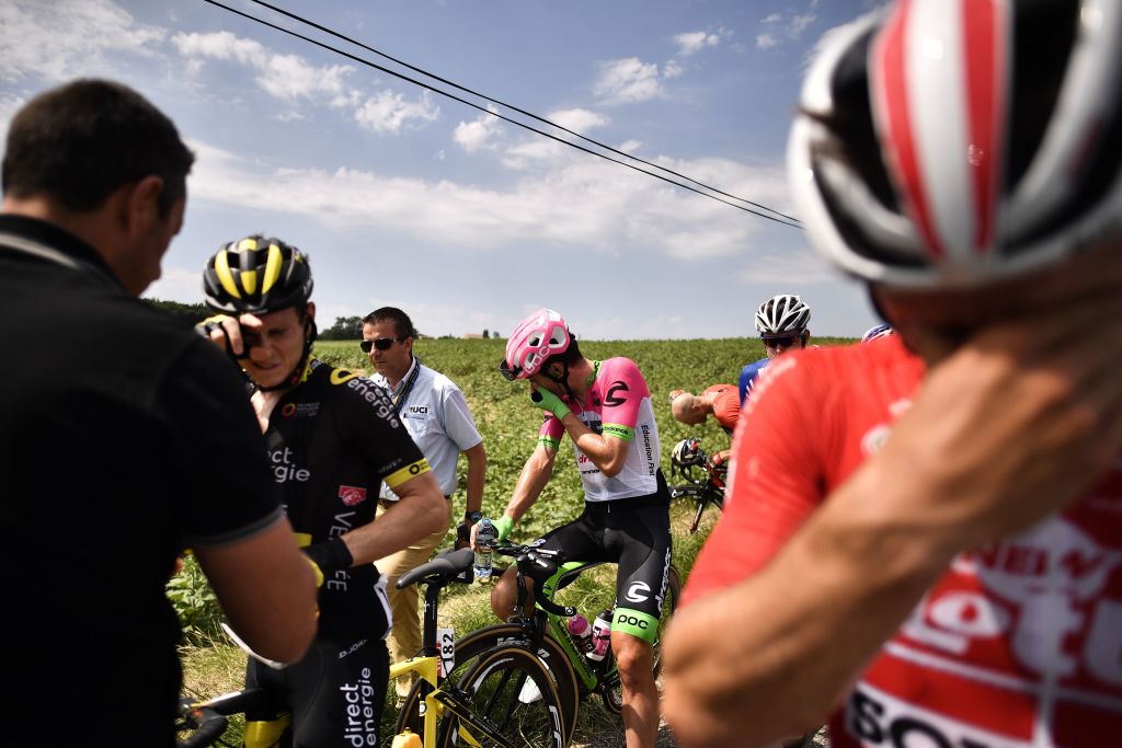 Riders react after riding through tear gas during a farmers' protest who attempted to block the stage's route, during the 16th stage of the 105th edition of the Tour de France cycling race, between Carcassonne and Bagneres-de-Luchon, southwestern France, on July 24, 2018. - The race was halted for several minutes on July 24 after tear gas was used as protesting farmers attempted to block the route. (MARCO BERTORELLO/AFP/Getty Images)