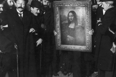 Officials gather around Leonardo da Vinci's 'Mona Lisa' (aka 'La Gioconda' or 'La Joconde') upon its return to Paris, 4th January 1914. It was stolen from the Musee du Louvre by Vincenzo Peruggia in 1911, and has only just been recovered. (Paul Thompson/FPG/Archive Photos/Getty Images)