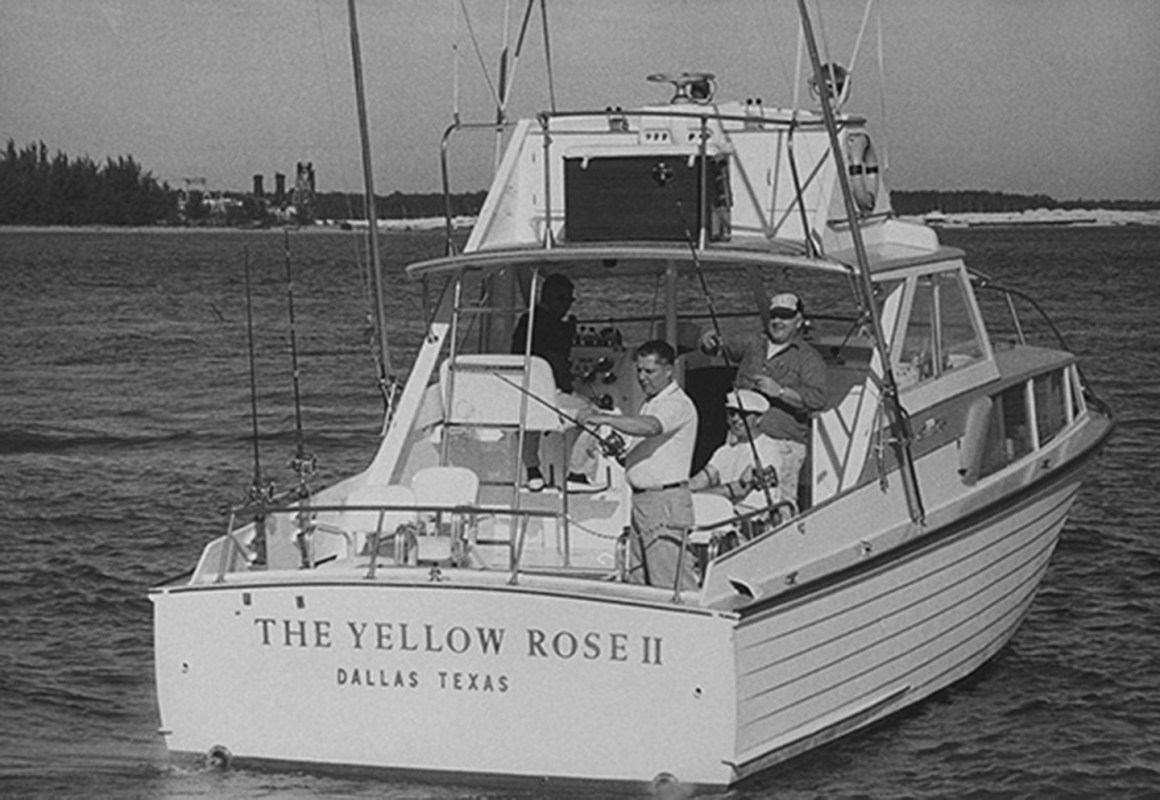 Teamster leader Jimmy Hoffa casting his reel into water off side of boat called The Yellow Rose II during fishing trip, w. his cohorts behind him, off coast of Miami, FL. (Photo by Frank Dandridge/Pix Inc./The LIFE Images Collection/Getty Images)