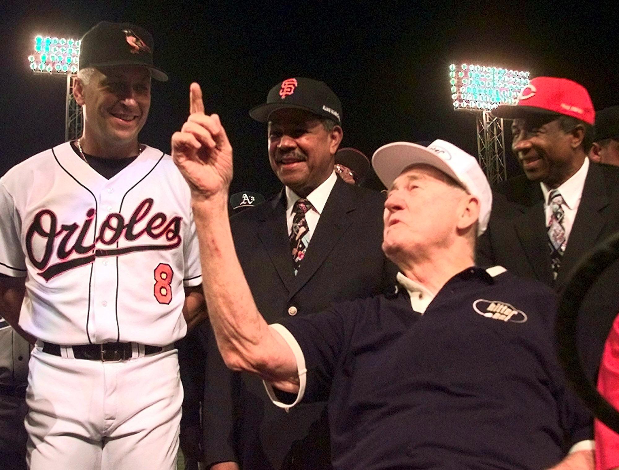 Baseball legend and former Boston Red Sox star Ted Williams (2ndR) talks with All-Star Cal Ripken, Jr. of the Baltimore Orioles (L), as All-Century players Juan Marichal (2ndL) and Frank Robinson (R) listen July 13, 1999 at Boston's Fenway Park prior to the start of the All-Star Game at Fenway Park. Williams threw out the honorary first pitch. (ELECTRONIC IMAGE) (Photo credit should read MATT YORK/AFP/Getty Images)