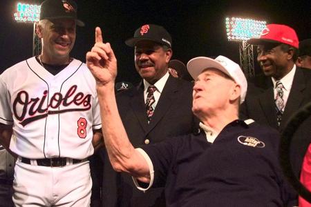 Baseball legend and former Boston Red Sox star Ted Williams (2ndR) talks with All-Star Cal Ripken, Jr. of the Baltimore Orioles (L), as All-Century players Juan Marichal (2ndL) and Frank Robinson (R) listen July 13, 1999 at Boston's Fenway Park prior to the start of the All-Star Game at Fenway Park. Williams threw out the honorary first pitch. (ELECTRONIC IMAGE)  (Photo credit should read MATT YORK/AFP/Getty Images)