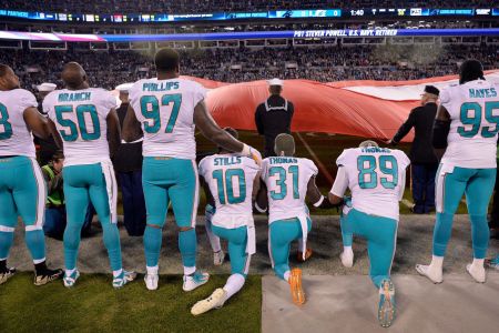Miami Dolphins players kneel during the national anthem before their game against the Carolina Panthers at Bank of America Stadium on November 13, 2017 in Charlotte, North Carolina.  (Photo by Grant Halverson/Getty Images)