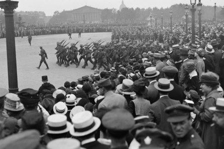 View over the crowd as they watch American troops march in the Place de la Concorde during a parade in celebration of US independence, Paris, France, July 4, 1918. (Lewis Hine/Interim Archives/Getty Images)
