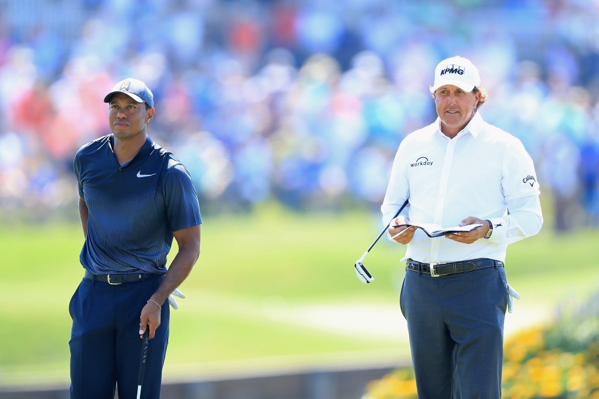 Tiger Woods of the United States and Phil Mickelson of the United States stand on the 16th green during the second round of THE PLAYERS Championship on the Stadium Course at TPC Sawgrass on May 11, 2018 in Ponte Vedra Beach, Florida.  (Photo by Sam Greenwood/Getty Images)