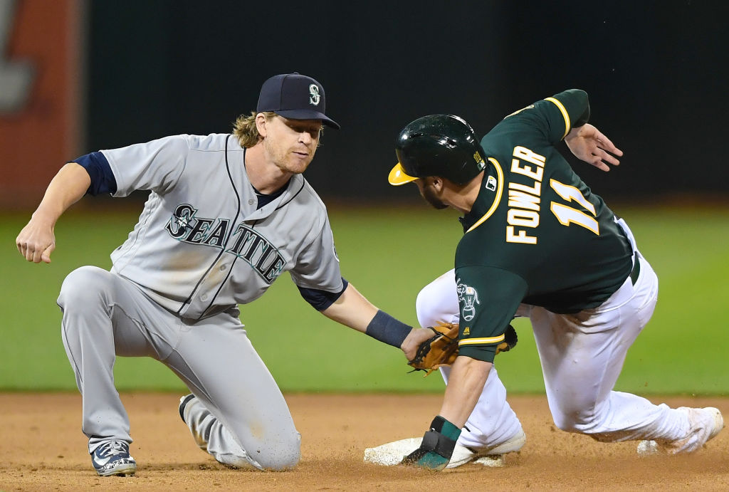 Dustin Fowler #11 of the Oakland Athletics gets caught attempting to steal second base tagged out by Gordon Beckham #1 of the Seattle Mariners in the bottom of the eighth inning at the Oakland Alameda Coliseum on May 23, 2018 in Oakland, California.  (Photo by Thearon W. Henderson/Getty Images)