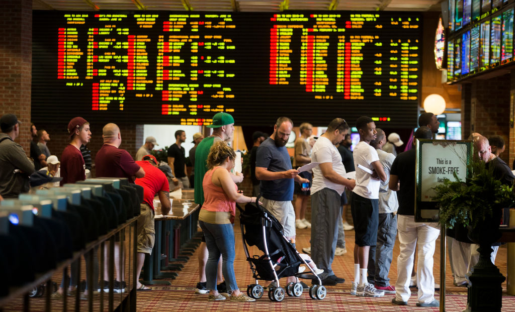 Patrons wait in long lines inside Vegas Sports Betting at Delaware Park Racetrack in Stanton, DE on June 10, 2018. In May, the US Supreme Court overturned a 1992 federal law that banned commercial sports betting in most states. Delaware became the first state to take advantage of the ruling, beginning June 5. (Photo by Stan Grossfeld/The Boston Globe via Getty Images)